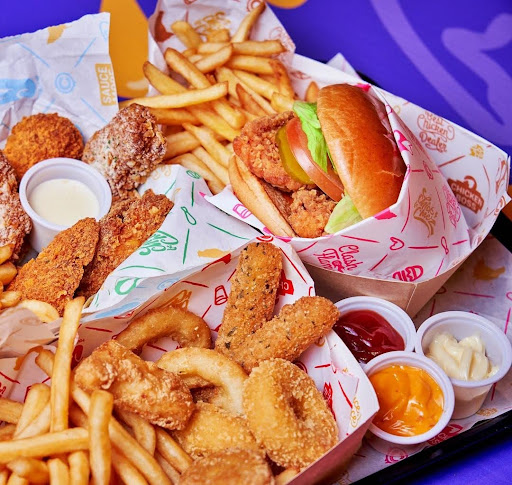 Variety of fried foods with sauces served on custom printed greaseproof paper